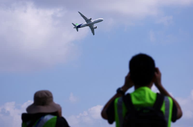 A Comac C919 flies past during an aerial flying display ahead of the Singapore Airshow at Changi Exhibition Centre in Singapore