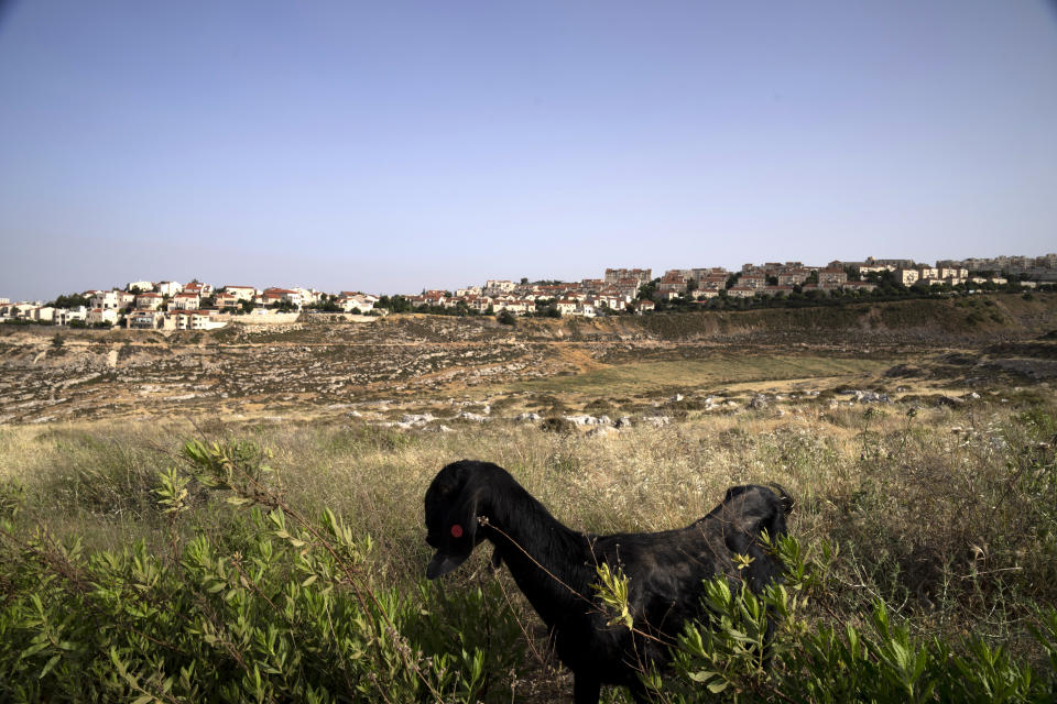 A Palestinian home sits in a valley, located next to the east Jerusalem Israeli settlement of Pisgat Ze'ev, Thursday, May 12, 2022. Israel advanced plans for the construction of more than 4,000 settler homes in the occupied West Bank on Thursday, a rights group said, a day after the military demolished homes in an area where hundreds of Palestinians face the threat of expulsion. (AP Photo/Maya Alleruzzo)
