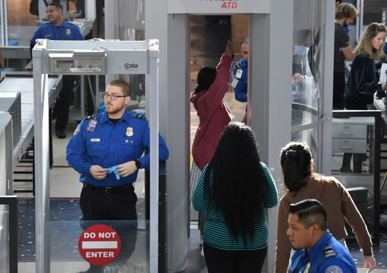 Transportation Security Administration officers work unpaid on the first day of the US government shutdown, at Los Angeles International Airport on December 22, 2018