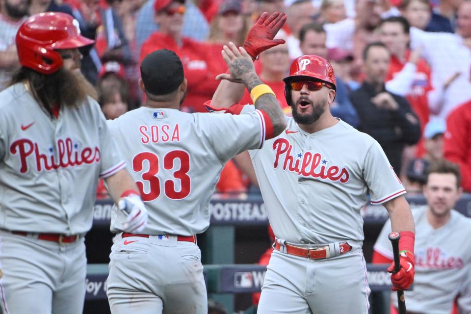 Phillies left fielder Kyle Schwarber congratulates shortstop Edmundo Sosa after his run scored in the ninth inning.