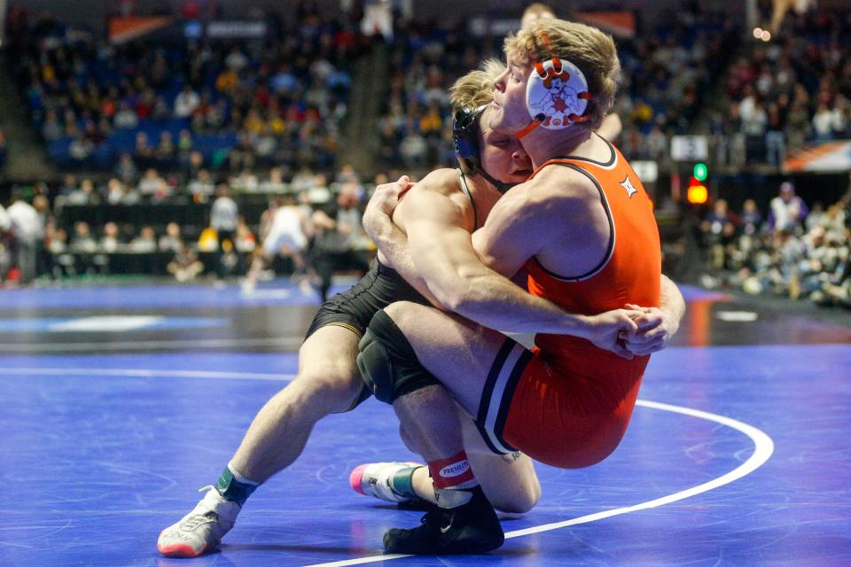 Iowa's Nelson Brands takes down Oklahoma State's Dustin Plott in the fifth-place match of the NCAA Championships' 174-pound division at BOK Center in Tulsa on Saturday.