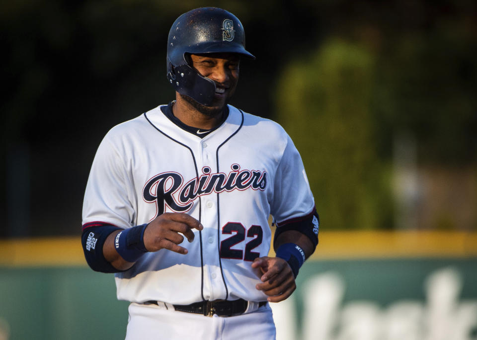 FILE - In this Monday, Aug. 6, 2018, file photo, Robinson Cano smiles on the field during his first rehab start with the Tacoma Rainiers at Cheney Stadium in Tacoma, Wash. Cano is set to return from his 80-game suspension for violating baseball's drug agreement when Seattle plays at Oakland. The All-Star second baseman has been out since May 15, though he’s been playing in the minor leagues for the past week. (Joshua Bessex/The News Tribune via AP, File)