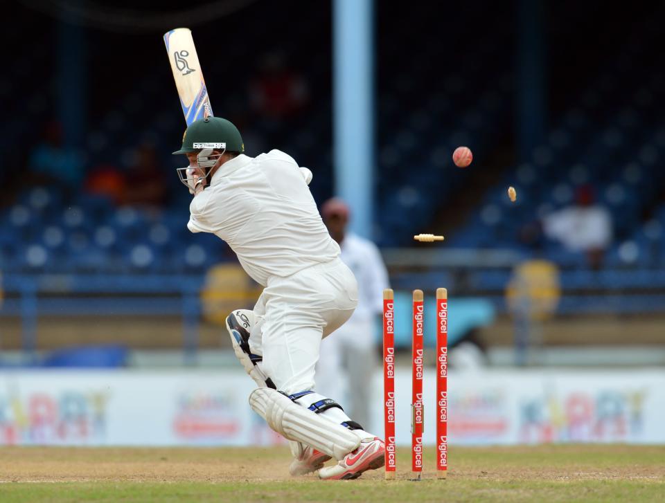 Australian batsman Michael Hussey is bowled out by West Indies Kemar Roach during the final day of the second-of-three Test matches between Australia and West Indies April19, 2012 at Queen's Park Oval in Port of Spain, Trinidad.