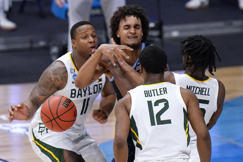 Villanova forward Jeremiah Robinson-Earl (24) loses the ball against Baylor guard Mark Vital (11), Davion Mitchell (45) and Jared Butler (12) in the second half of a Sweet 16 game in the NCAA men's college basketball tournament at Hinkle Fieldhouse in Indianapolis, Saturday, March 27, 2021. (AP Photo/AJ Mast)