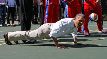 <p>President Barack Obama does push-ups while playing basketball during the 2012 White House Easter Egg Roll on the South Lawn in Washington April 9, 2012. (Kevin Lamarque/Reuters) </p>