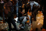 Protesters are pushed by Mossos d'Esquadra riot officers outside the Catalan region's economy ministry building during a raid by Spanish police on government offices, in Barcelona, Spain, early September 21, 2017. REUTERS/Jon Nazca