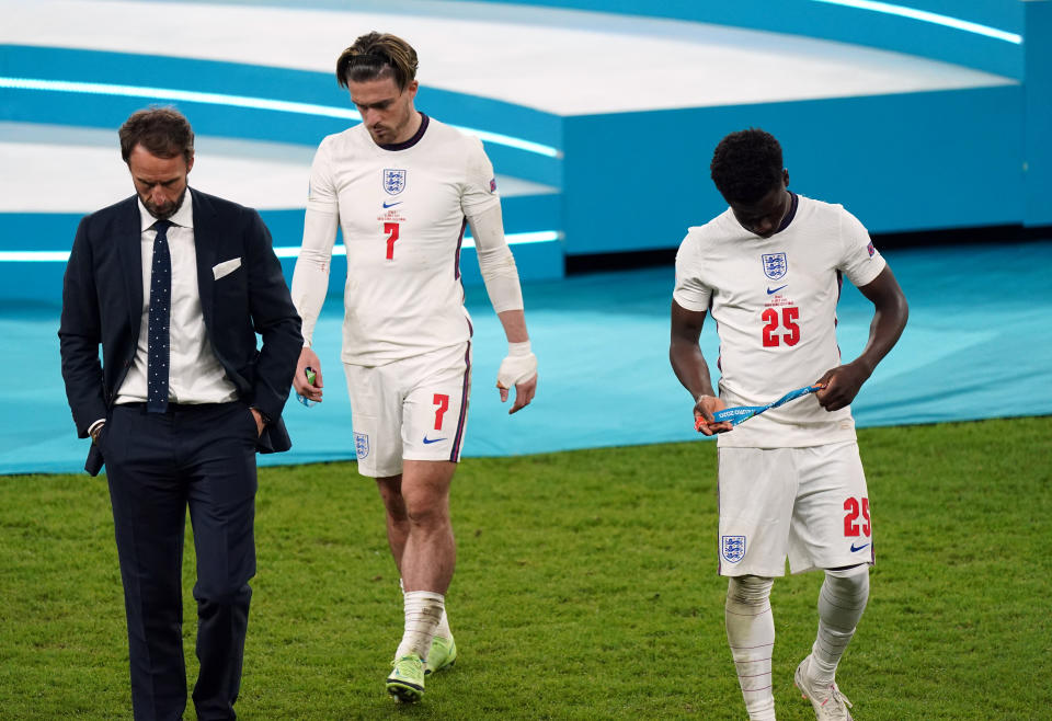 England manager Gareth Southgate stands dejected alongside Bukayo Saka and Jack Grealish following the UEFA Euro 2020 Final at Wembley Stadium, London. Picture date: Sunday July 11, 2021.