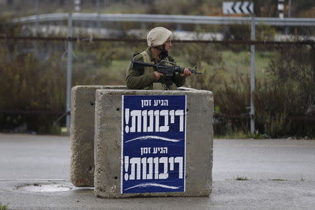 An Israeli soldier secures the scene where Israeli security forces shot dead a Palestinian assailant who tried to stab a man at Gush Etzion junction, near a West Bank settlement on Tuesday, police said, a location that has seen many attacks during two months of violence. December 1, 2015. REUTERS/Baz Ratner