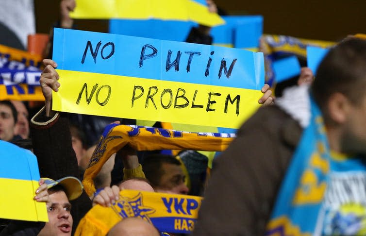 Ukraine football fans holding up a sign that says No Putin No Problem.