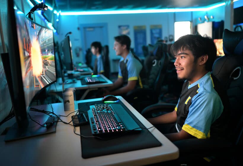 Reuben Estrada reacts while sitting at a school computer during an e-sports competition at Quartz Hills High