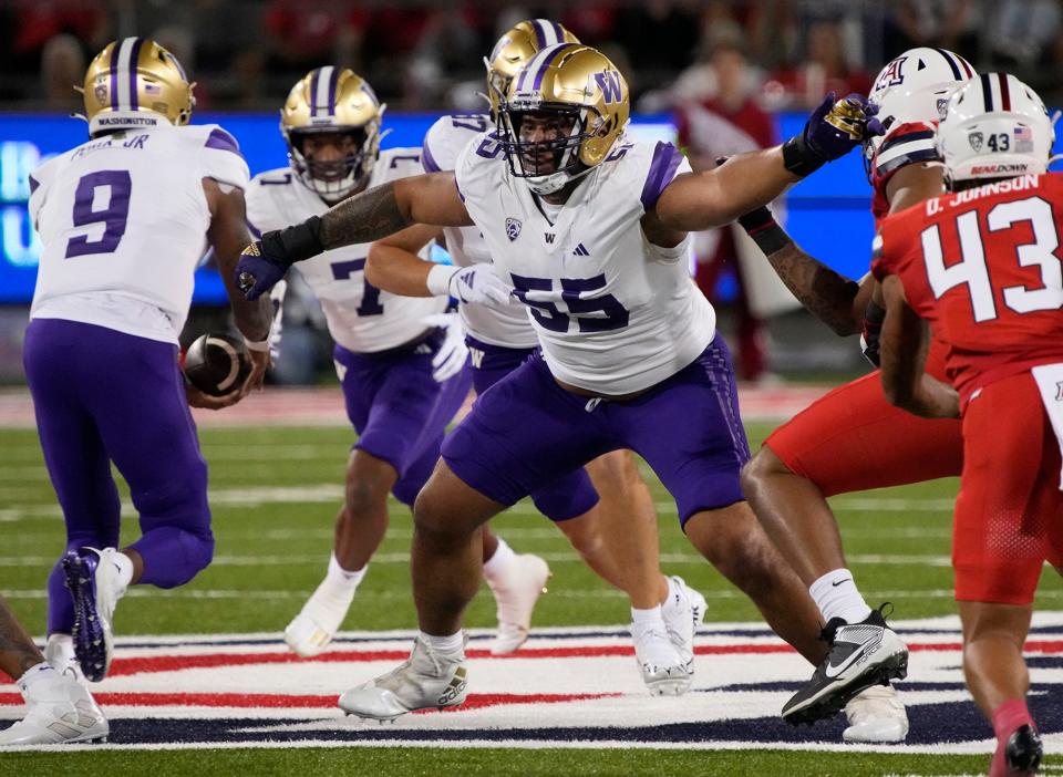Washington offensive lineman Troy Fautanu (55) blocks for running back Dillon Johnson against Arizona in September. Fautanu and the Huskies' offensive line paved the way for No. 2 Washington to make the College Football Playoff, where they face No. 3 Texas in the Sugar Bowl.