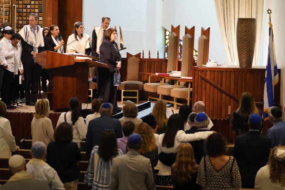 People sing the Israeli national anthem to conclude the service during Shabbat at The Sinai Temple in Los Angeles on Saturday, Oct. 14, 2023. The temple's worshippers, the majority of whom have family in Israel, were on edge after recent pro-Palestine rallies elsewhere in Los Angeles. The Shabbat service, themed "Sinai Temple Stands with Israel," featured prayers and songs for Israel, including the Israeli national anthem, to conclude the service as several people in the audience waved small Israeli flags. (AP Photo/Damian Dovarganes)