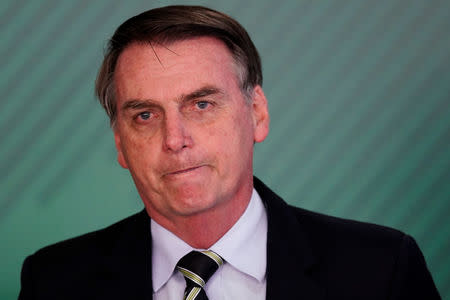 Brazil's President Jair Bolsonaro reacts during a signing ceremony of the decree which eases gun restrictions in Brazil, at the Planalto Palace in Brasilia, Brazil January 15, 2019. REUTERS/Ueslei Marcelino