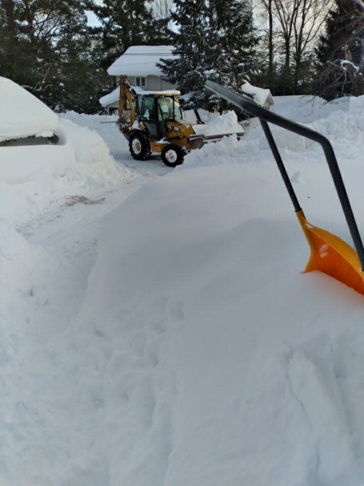 Painesdale, Mich. resident Ronnie Jackson says he had to hire a tractor operator to dig a path to his home following a record-breaking snow storm. Image provided by Ronnie Jackson.