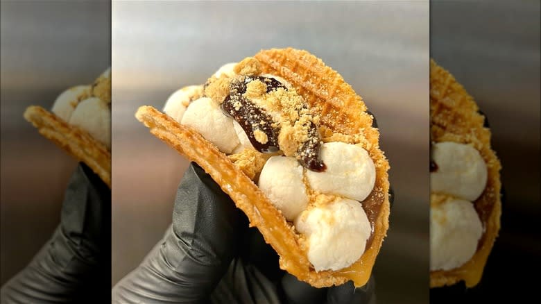 gloved hand holding a S'mores stroopwafel 