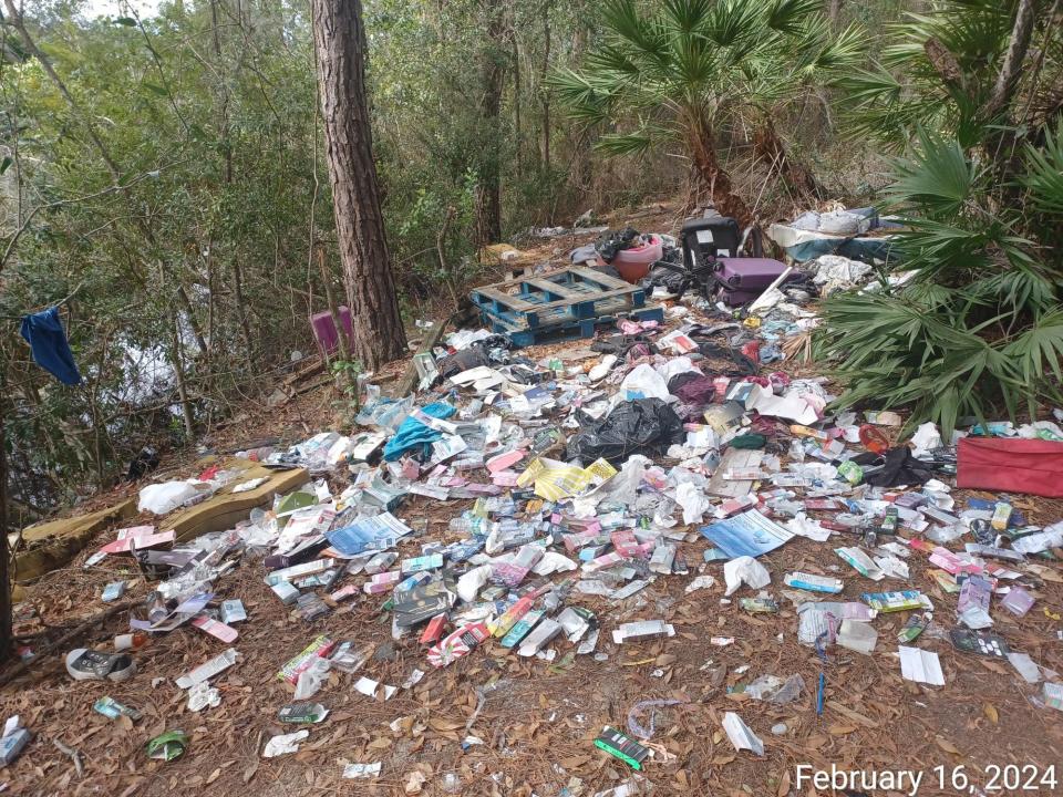 Homeless people living in a makeshift encampment behind the Beville Road Publix in Daytona Beach appear to have created a dump for their trash.