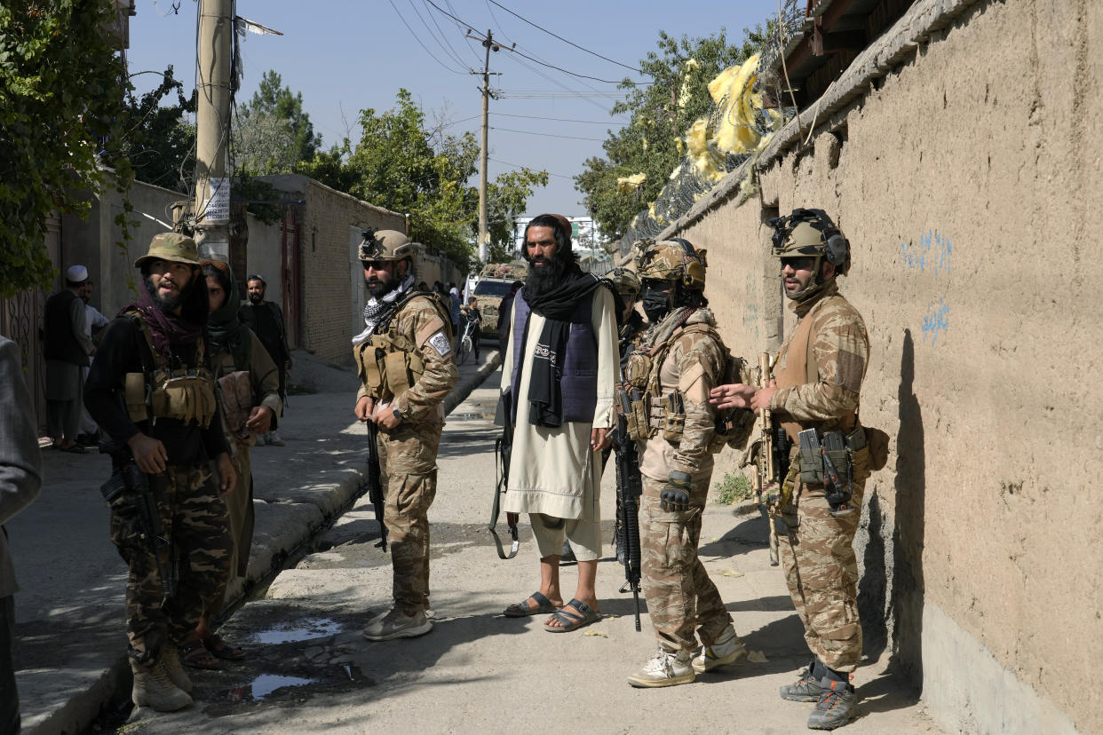 Taliban fighters stand guard in front of an education center that was attacked by a suicide bomber, in Kabul, Afghanistan, Friday, Sept. 30, 2022. A Taliban spokesman says a suicide bomber has killed several people and wounded others at an education center in a Shiite area of the Afghan capital. The bomber hit while hundreds of teenage students inside were taking practice entrance exams for university, a witness says. (AP Photo/Ebrahim Noroozi)
