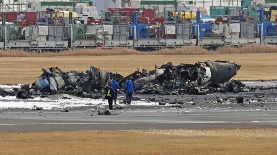 The burn-out Japanese coast guard aircraft is seen at Haneda airport on January 3, 2024, in Tokyo, Japan. - Kyodo News/AP