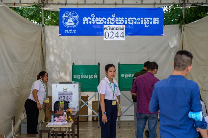 Voters cast their ballots at a polling station on the riverfront in Phnom Penh Sunday. Photo by Thomas Maresca/UPI