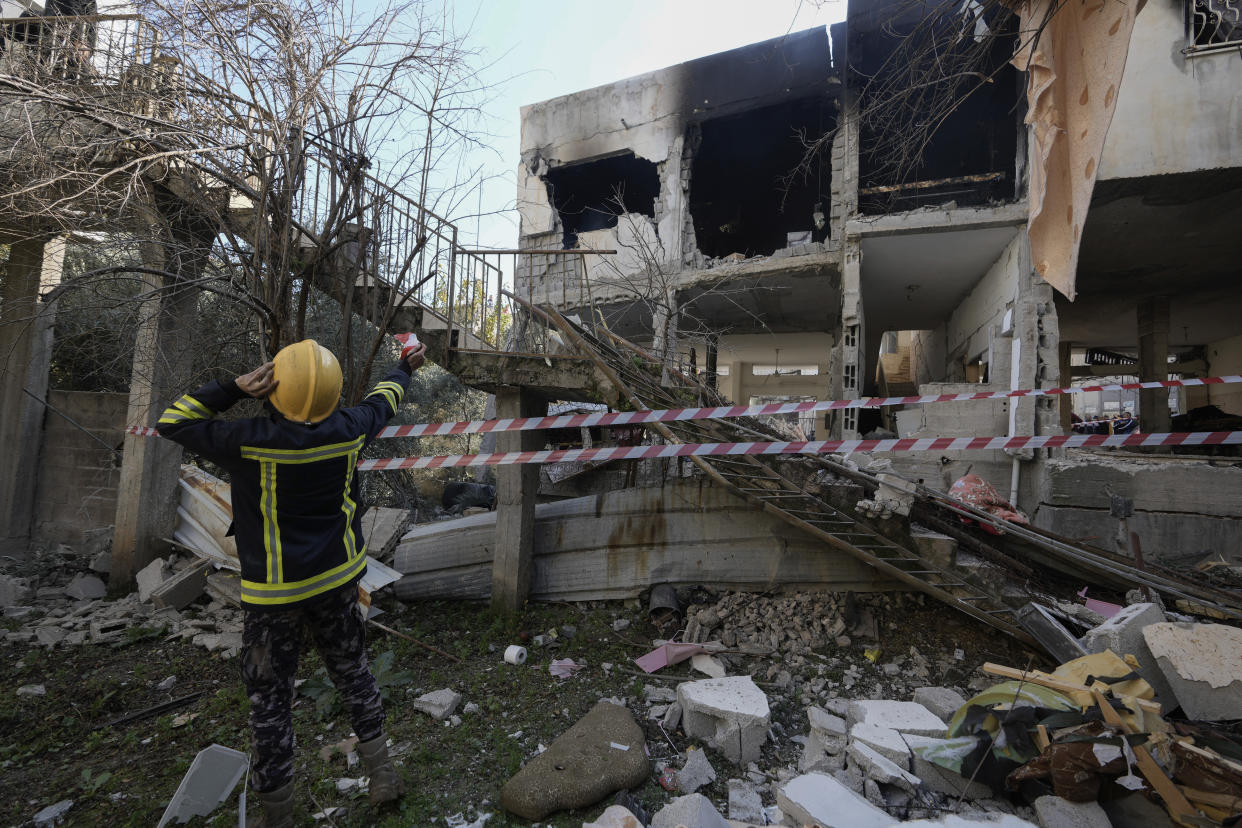 Palestinian rescuers inspect the site of a damaged building following an Israeli forces raid in the West Bank city of Jenin, Thursday, Jan. 26, 2023. Israeli forces killed at least nine Palestinians, including a 60-year-old woman, and wounded several others during a raid in the flashpoint area of the occupied West Bank, Palestinian health officials said, in one of the deadliest days of fighting in years. The Israeli military said it was conducting an operation to arrest militants when a gun battle erupted. (AP Photo/Majdi Mohammed)