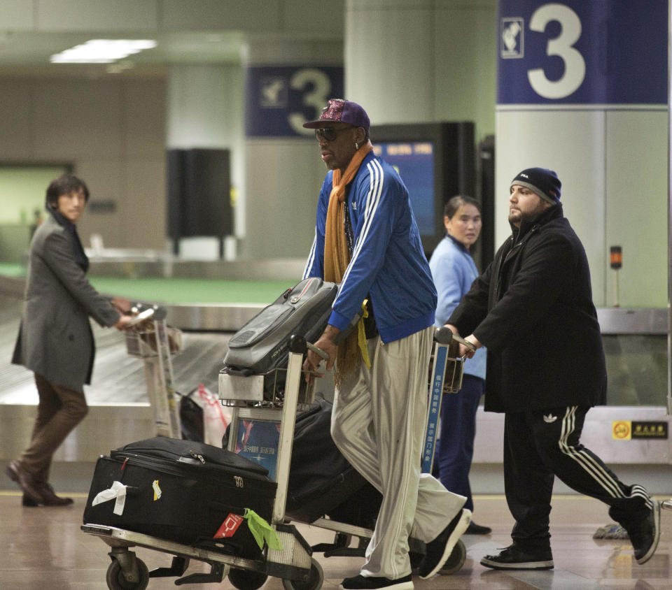 Former NBA basketball player Dennis Rodman pushes his luggage cart as he arrives at the Capital International Airport in Beijing from Pyongyang, Monday, Jan. 13, 2014. Rodman has checked into an undisclosed alcohol rehabilitation center to treat his long-time struggle with alcoholism, his agent says. (AP Photo/Alexander F. Yuan)