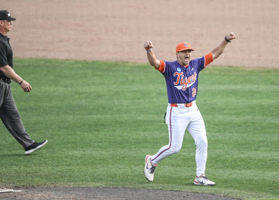 Clemson Head Coach Erik Bakich pumps his fists toward fans after he argued with umpires following his ejection during the top of the 13th inning at the NCAA baseball Clemson Super Regional at Doug Kingsmore Stadium in Clemson Sunday, June 9, 2024.