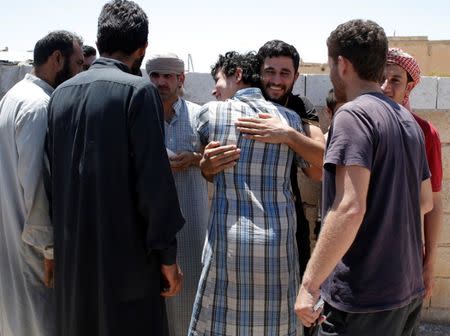 A relative greets an Islamic State prisoner who was pardoned by a council that is expected to govern Raqqa once the group is dislodged from the Syrian city in Ain Issa village, north of Raqqa, Syria June 24, 2017. REUTERS/Goran Tomasevic