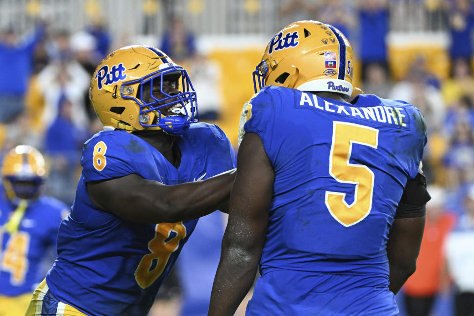 Pittsburgh defenders Calijah Kancey (8) and Deslin Alexandre (5) celebrate a safety during the second half of an NCAA college football game against Syracuse, Saturday, Nov. 5, 2022, in Pittsburgh. Pittsburgh won 19-9. (AP Photo/Barry Reeger)