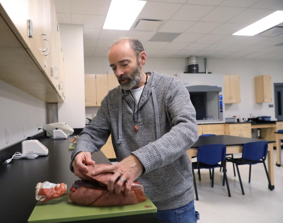 DCC biology professor Mark Condon inspects a model of a human lung at a lab at DCC's campus in Fishkill on January 10, 2024. Condon is heading up the college's cannabis management program.