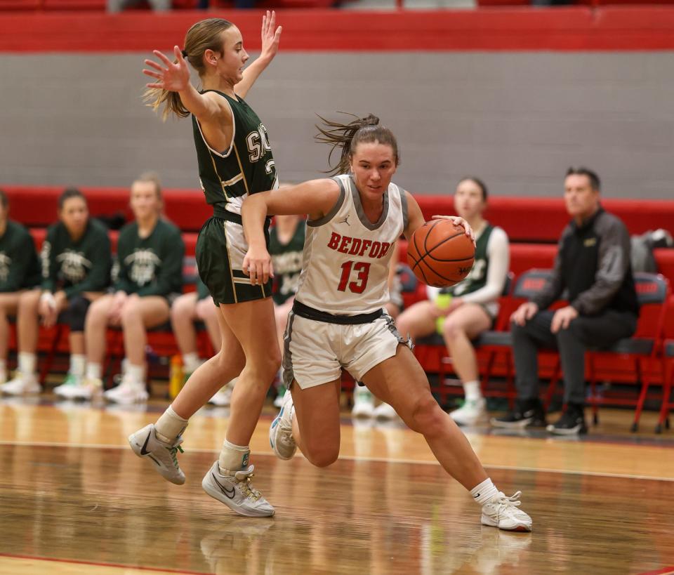 Payton Pudlowski of Bedford (13) drives the baseline against St. Mary Catholic Central’s Bella LaFountain during a 48-33 Bedford win Friday night.