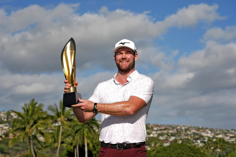 Grayson Murray holds the trophy after winning the Sony Open golf event, Sunday, Jan. 14, 2024, at Waialae Country Club in Honolulu. (AP Photo/Matt York)