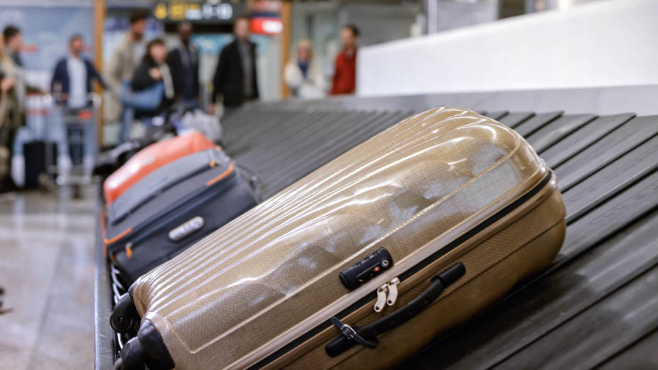 Business people standing at baggage claim in airport.