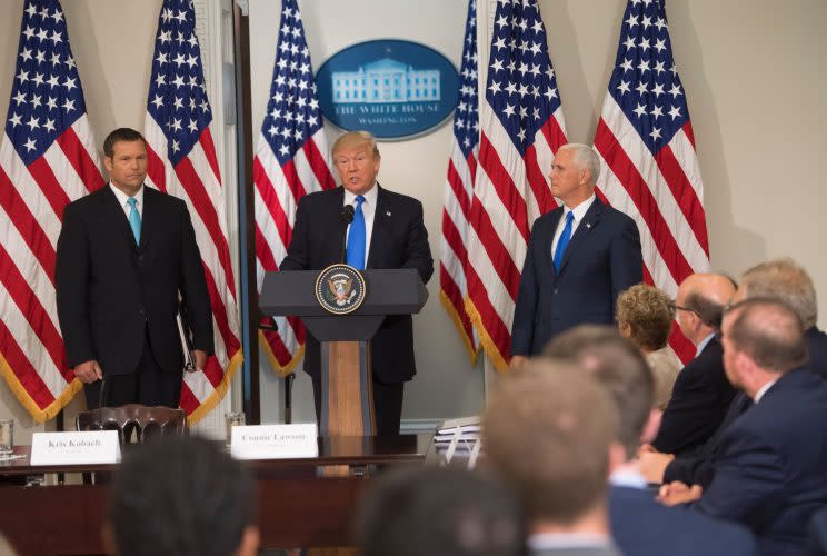 President Trump speaks alongside Kansas Secretary of State Kris Kobach, left, and Vice President Mike Pence during the first meeting of the Presidential Advisory Commission on Election Integrity in the Eisenhower Executive Office Building next to the White House in Washington, D.C., on July 19, 2017. (Photo: Saul Loeb/AFP/Getty Images)