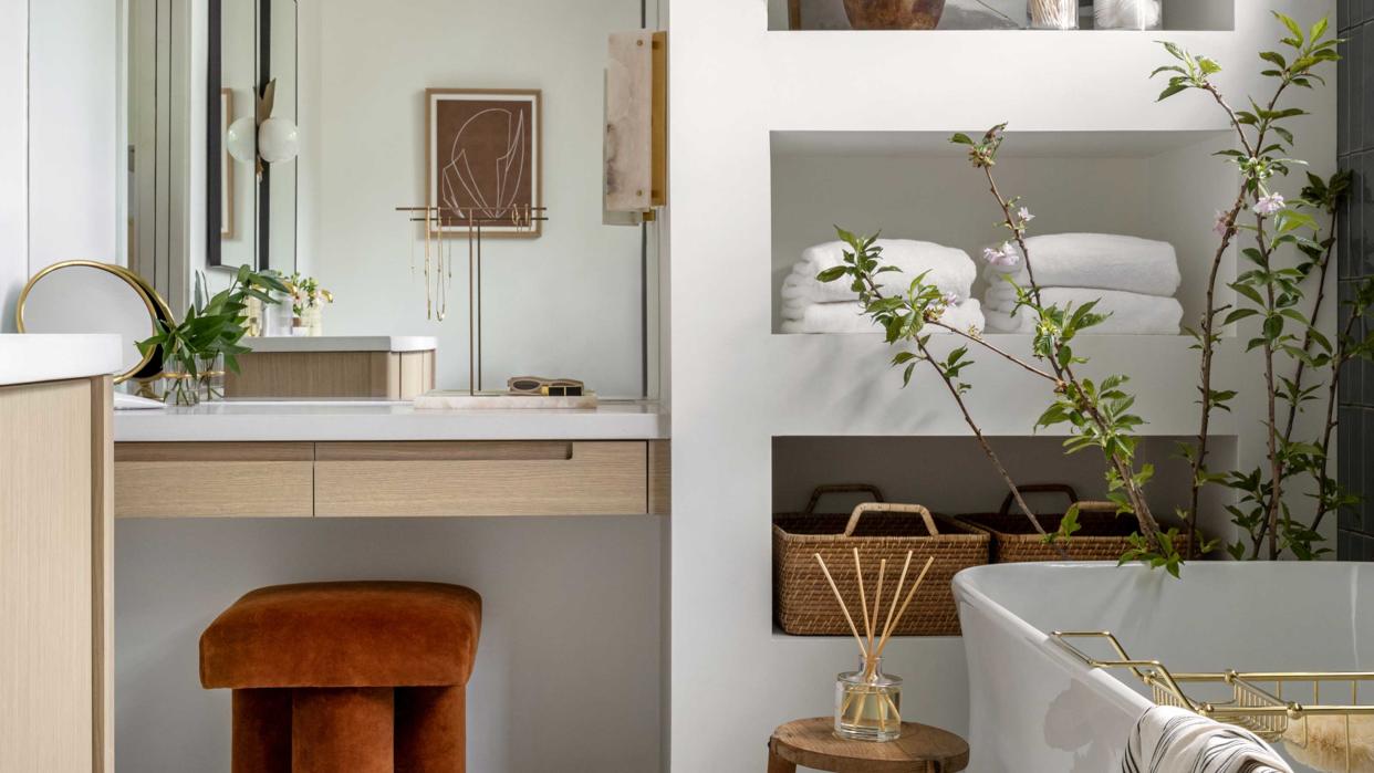  bathroom with tub and storage alcoves for baskets and towels 