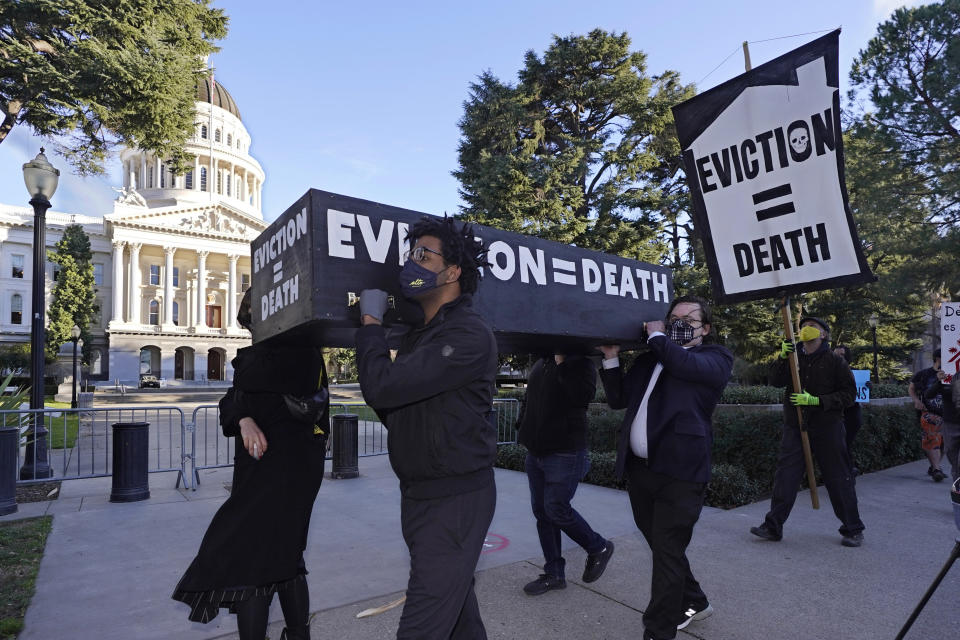 FILE — In this Jan. 25, 2021, file photo, demonstrators call passage of rent forgiveness and stronger eviction protections legislation and carry a mock casket past the Capitol in Sacramento, Calif. California Gov. Gavin Newsom and state legislative leaders are negotiating about whether to extend the state's ban on evictions for unpaid rent. California's eviction protections will expire on June 30. Newsom has proposed using federal coronavirus aid money to pay off 100% of the rent people owe. (AP Photo/Rich Pedroncelli, File)