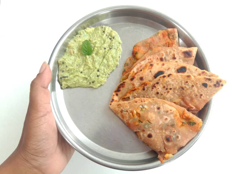 Aloo paratha with chutney on stainless steel plate