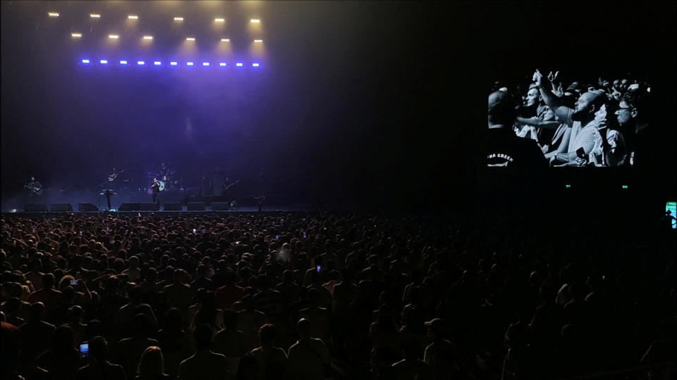 People in the audience are seen on a large screen as they boo during a concert by American alternative-rock band The Killers after lead singer Brandon Flowers invited a Russian drummer to the stage, in Batumi, Georgia, August 15, 2023, in this picture obtained from social media video. / Credit: Ekaterina Pirogova via Reuters