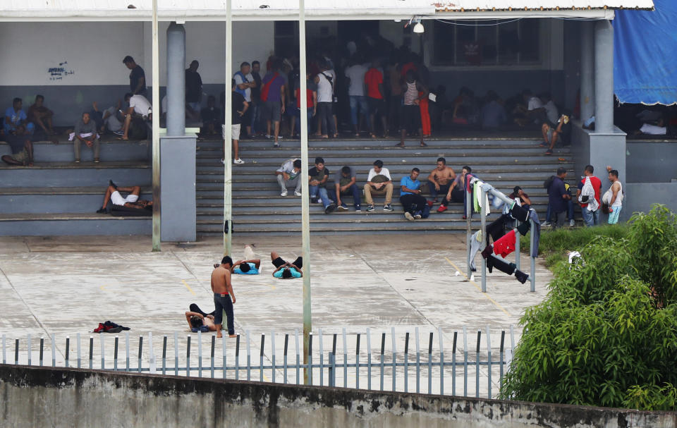 In this June 1, 2019 photo, migrants mill around a courtyard of Siglo XXI migrant detention center in Tapachula, Chiapas state, Mexico. An average stay for a migrant at the overcrowded detention center will not last more than two weeks. (AP Photo/Marco Ugarte)