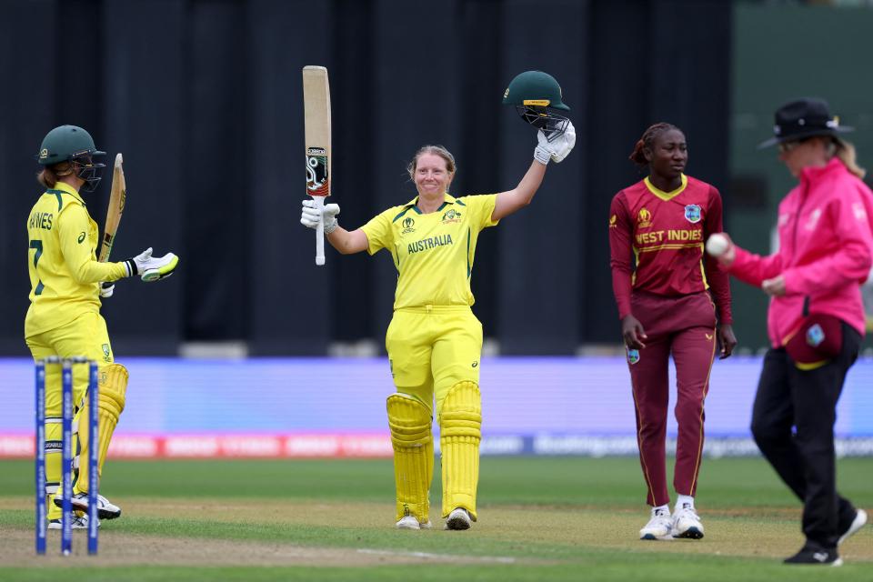 Pictured centre, Australia's Alyssa Healy raises the bat after her century against the West Indies in the Women's Cricket World Cup semi-final.