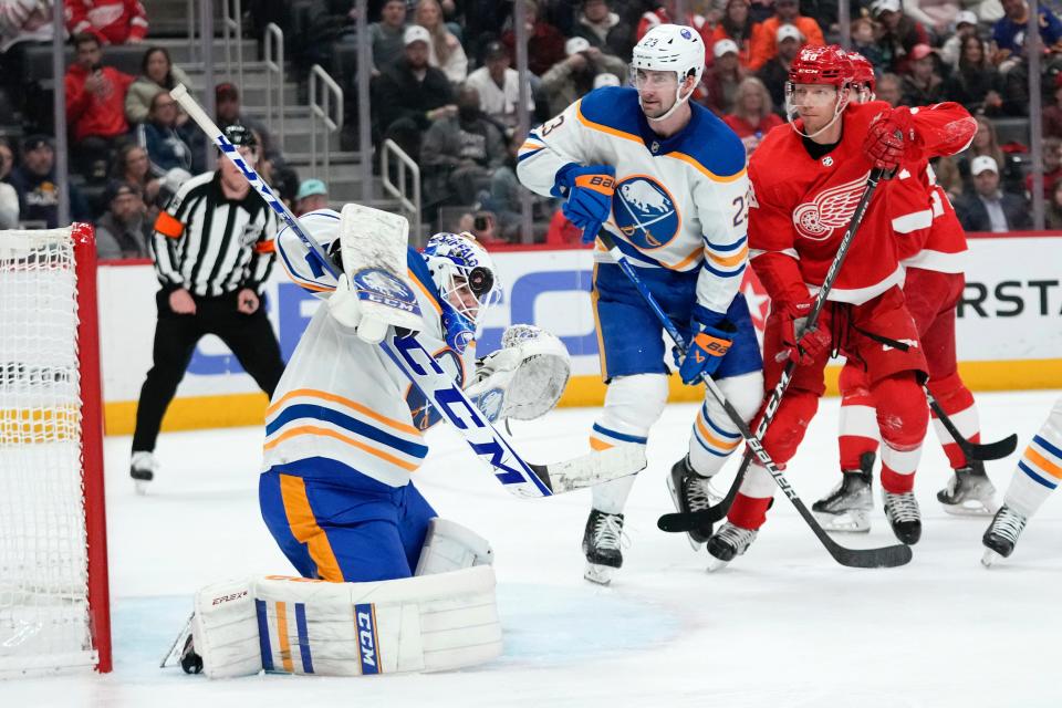 Buffalo Sabres goaltender Devon Levi (27) stops a Detroit Red Wings shot with his mask in the second period at Little Caesars Arena in Detroit on Thursday, April 6, 2023.