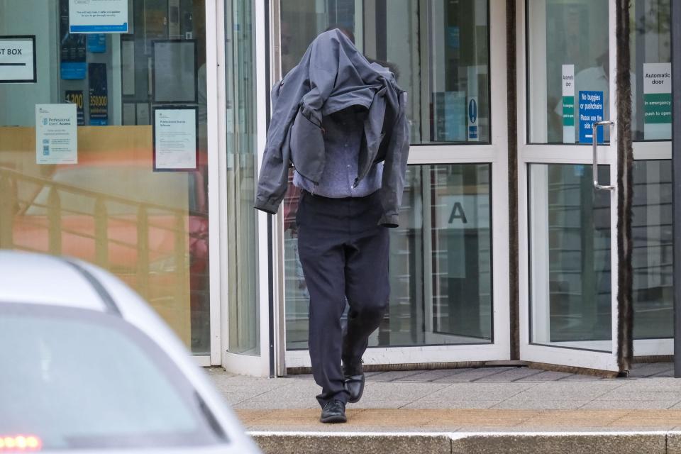 Civilian police worker Timothy Schofield, the brother of TV presenter Phillip Schofield, covers his head as he leaves Exeter Crown Court where he is on trial accused of sexual abuse of a teenager. Schofield, 54, is accused of 11 charges of interfering with a child which started when the victim was just a teenager. Picture date: Thursday March 30, 2023.