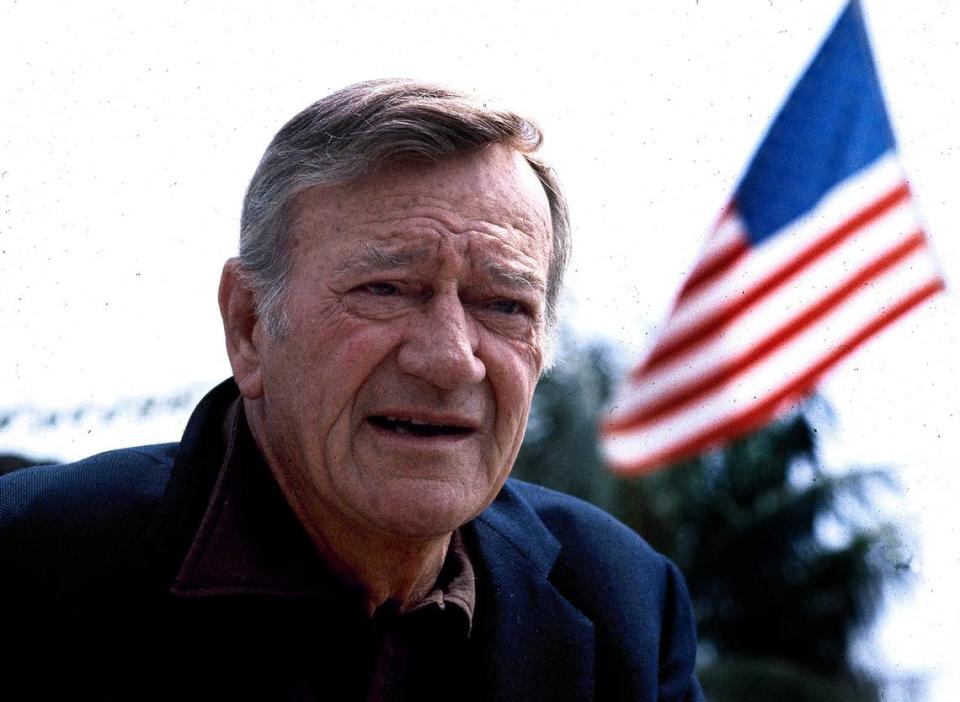 FILE - This 1978 file photo shows actor John Wayne. Wearing a brown plaid coat worn by Wayne in 1945’s “Flame of Barbary Coast,” Republican Lt. Gov. Dan Patrick has declared a day in honor of the quintessential screen cowboy as he presided over the Senate Tuesday, May 26, 2015. He declared it John Wayne Day in Texas to mark the Hollywood legend’s 108th birthday and named the actor an honorary Texan. (AP Photo, File)