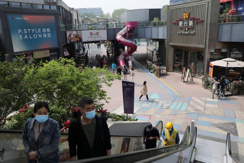 People visit a shopping complex in Beijing