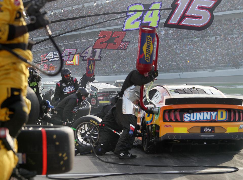 Pit crew members go to work on their cars, Saturdauy night February 19, 2023 during the Daytona 500.