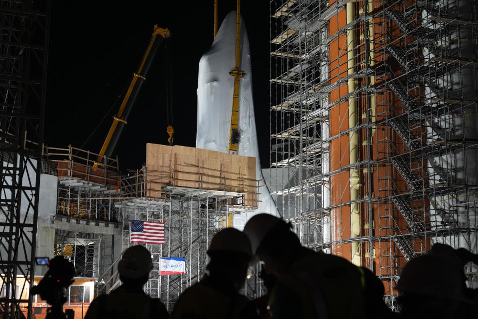 Space Shuttle Endeavour is lifted into the site of the future Samuel Oschin Air and Space Center on Monday, Jan. 29, 2024, in Los Angeles. (AP Photo/Ashley Landis)