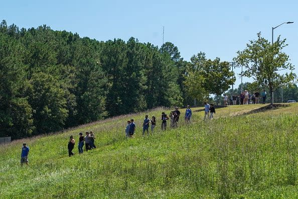 WINDER, GEORGIA - SEPTEMBER 4: Students walk off campus with their families after a shooting at Apalachee High School on September 4, 2024 in Winder, Georgia. Four fatalities and multiple injuries have been reported, and a 14-year-old suspect is in custody according to authorities. (Photo by Megan Varner/Getty Images)