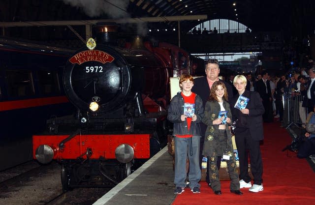 Actors Robbie Coltrane (back) and (from left) Rupert Grint, Emma Watson and Warwick Davis at Kingscross station in central London at the DVD and video launch party for 