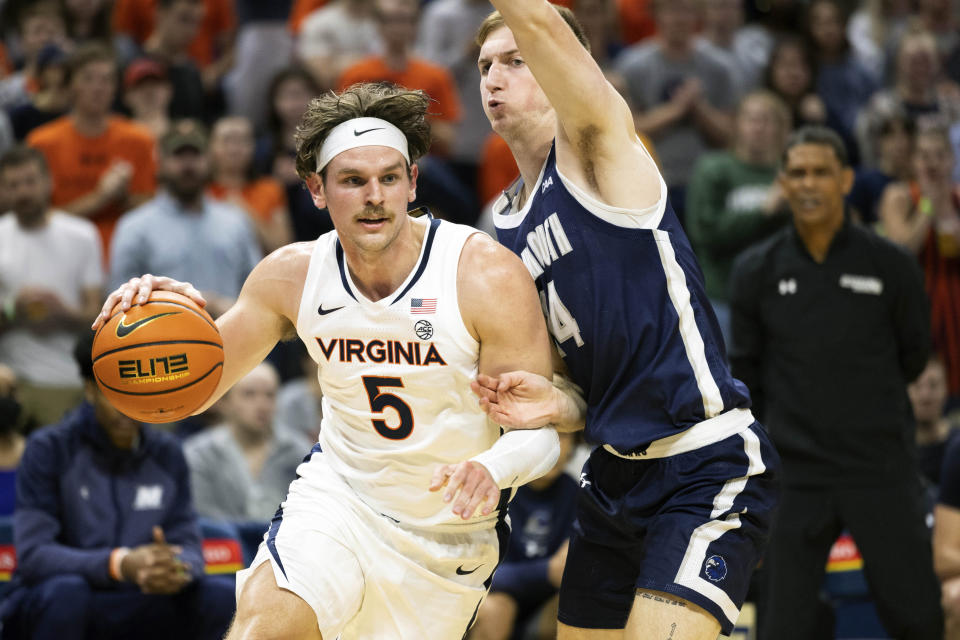 Virginia's Ben Vander Plas (5) drives with the ball against Monmouth during the first half of an NCAA college basketball game in Charlottesville, Va., Friday, Nov. 11, 2022. (AP Photo/Mike Kropf)