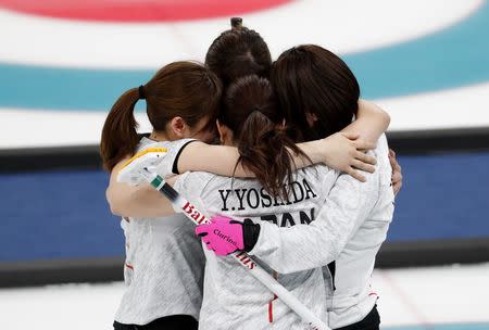 Curling - Pyeongchang 2018 Winter Olympics - Women's Bronze Medal Match - Britain v Japan - Gangneung Curling Center - Gangneung, South Korea - February 24, 2018 - Japan's curlers embrace after winning the match. REUTERS/Cathal McNaughton