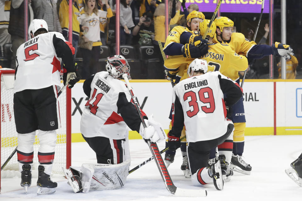 Nashville Predators right wing Viktor Arvidsson (33), of Sweden, is congratulated by Ryan Johansen (92) and Matt Duchene (95) after Arvidsson scored against Ottawa Senators goaltender Craig Anderson (41) in the second period of an NHL hockey game Tuesday, Feb. 25, 2020, in Nashville, Tenn. (AP Photo/Mark Humphrey)